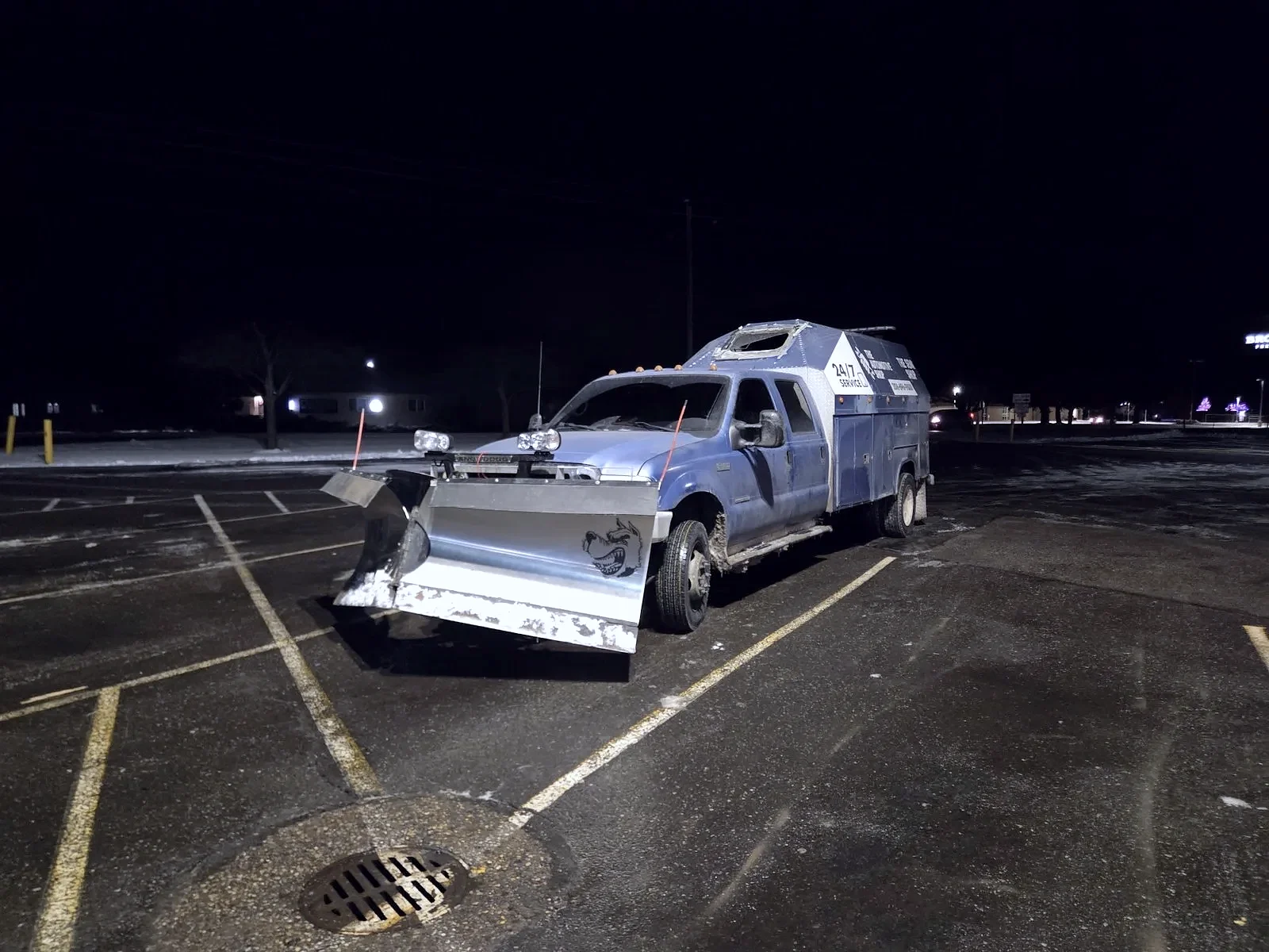 The Automotive Shop 24/7 service truck with snow plow on a winter night in Jerome, Idaho