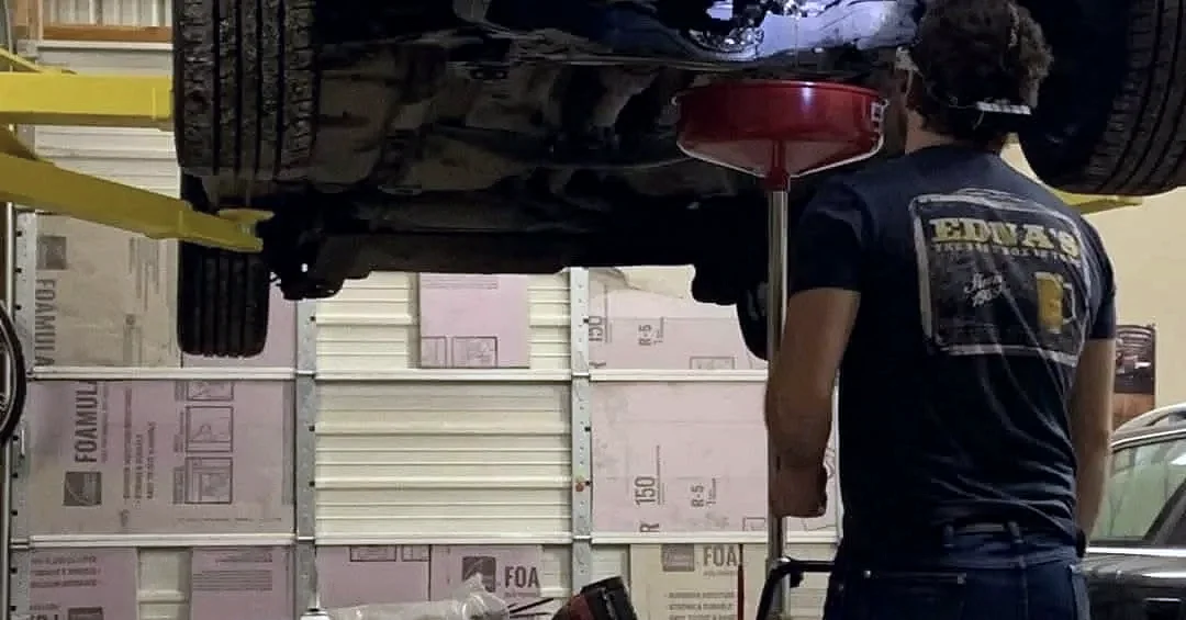 A technician performing an oil change in Jerome, Idaho